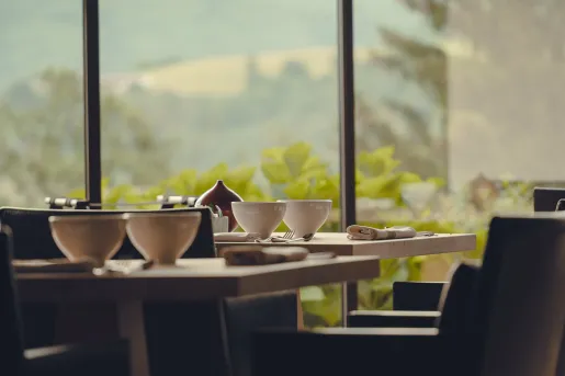 Indoor dining area, with a table and two cups of coffee on the table