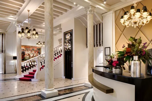 Hotel foyer with a staircase and concierge desk