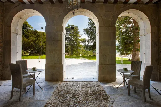 Stone seating area with arches leading to an outdoor courtyard