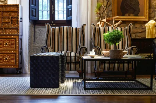 Stone-walled room with two cushioned seats and a coffee table in the center