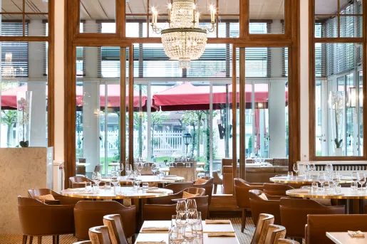 Indoor dining area with leather seats and wine glasses on each table