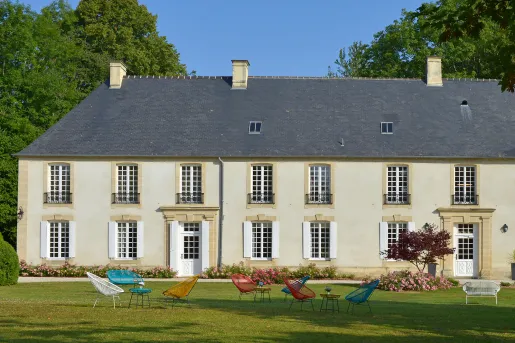 château with colorful chairs on the lawn