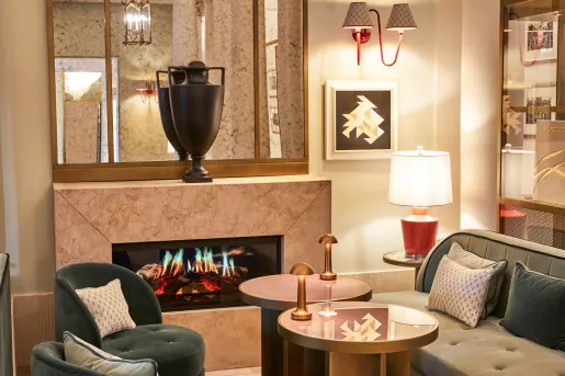 Indoor lounge with a fireplace and a vase on top