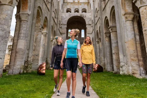three backroads guests walk through a stone structure