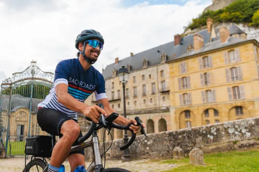 biker riding by large estate