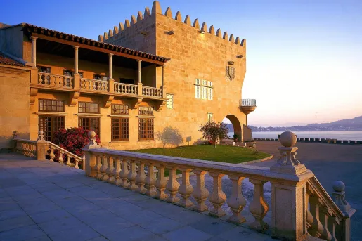 patio with stone railing next to hotel building