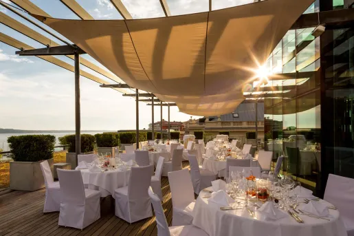 White dining tables on a large patio