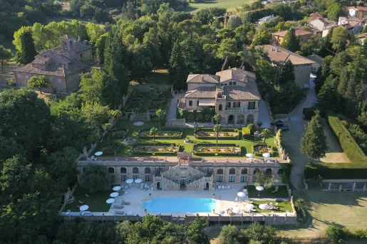 Sky view of stone building, with an outdoor garden and an outdoor pool