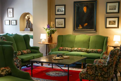Indoor lobby with green sofas and painting on the walls
