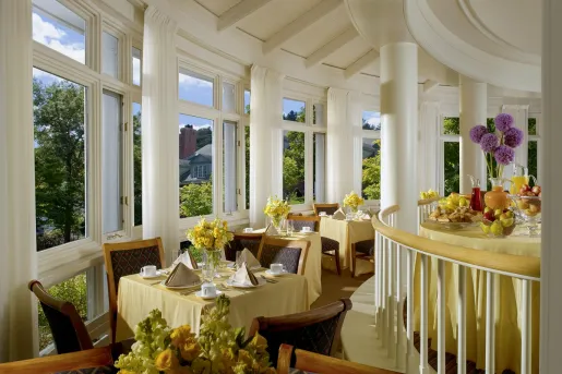 Circular room and dining area, with yellow tables and wooden chairs
