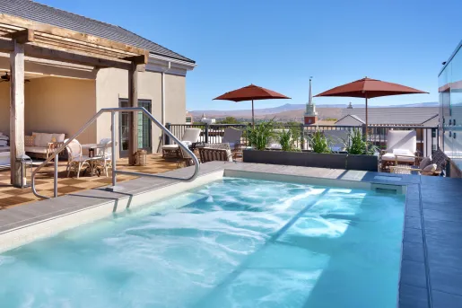 Outdoor pool on a roof, looking out to a small town in the distance