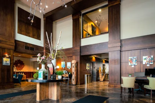 Indoor lobby with a wooden table and vase centerpiece
