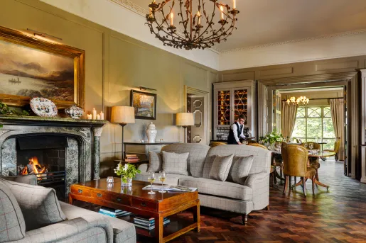 grand living room with fireplace and chandelier