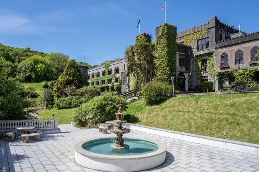 Outdoor courtyard with a circular fountain in the middle of a stone walway