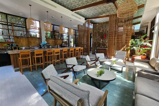 Indoor lobby with chairs and a bar island with stools