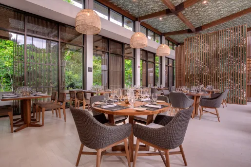 Indoor dining hall with glasses of wine on each table