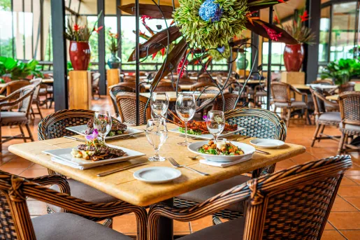 Dining table with plates of steak and lobster, with 4 glasses of wine