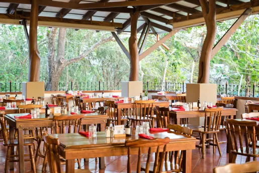 Outdoor patio and dining area with wooden tables and chairs