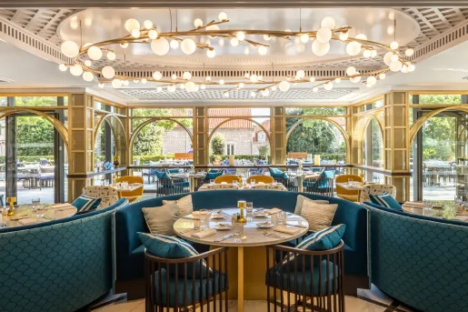 dining room with blue seating and large chandelier