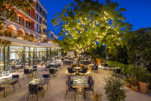 outdoor dining patio under lit up tree