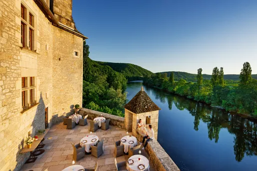 dining tables on outside patio by the river