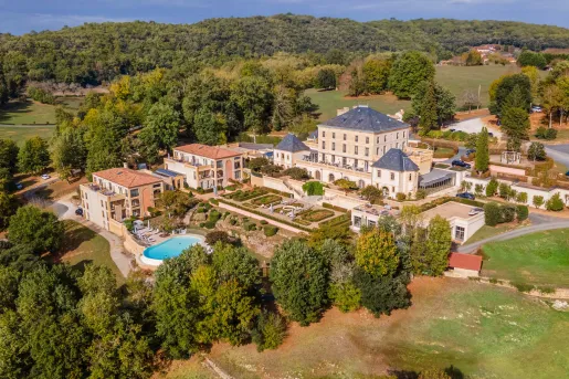 outdoor view of large hotel surrounded by trees