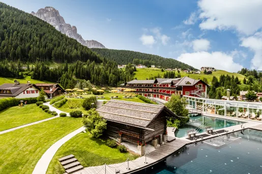 rolling green hills with hotel buildings