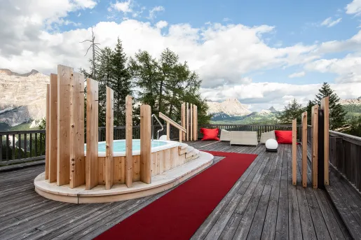 Rooftop deck with a hot tub, looking out to mountains