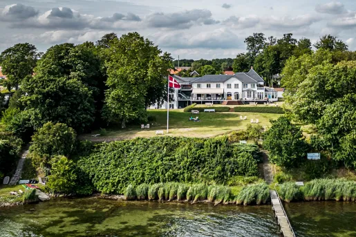 large house on a hill by the water