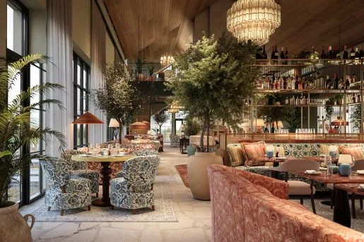 Indoor dining hall with blue and red cushioned seats and a wine rack in the center