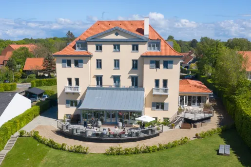 Outdoor view of hotel building with outdoor patio
