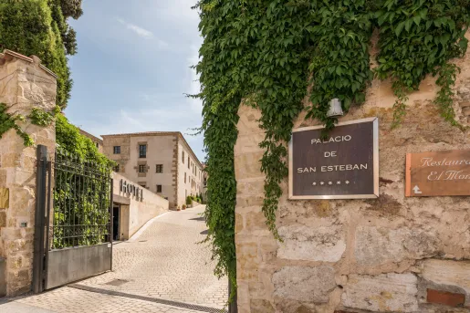 Hotel entrance with sign and green plants