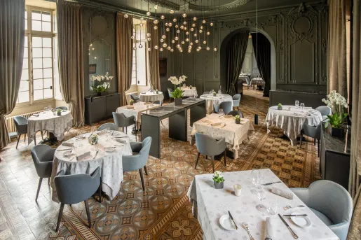 ballroom with dining tables and a chandelier