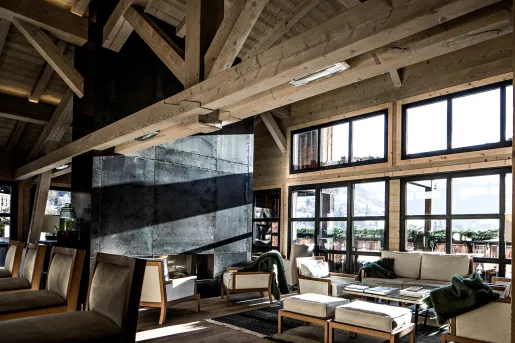 Lounge with wooden interior looking out to the forest