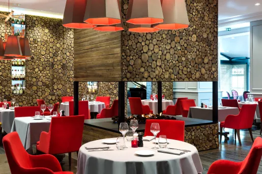 dining room with red chairs and fireplace in the middle