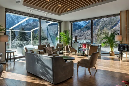 Indoor lounge with large windows looking out to mountains