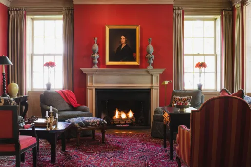red living room with fireplace and portrait