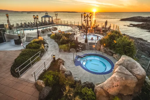Bids eye view of hot tub and pool area at sunset