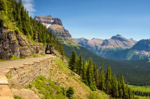 Long road along a cliff with trees in the distance