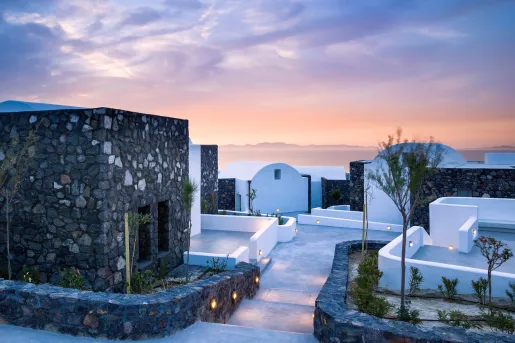 Gray and white stone villas with pathways leading to each doorway