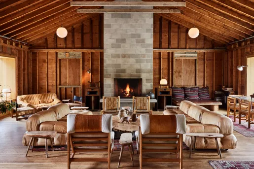 Indoor cottage lobby filled with leather couches and wooden furniture