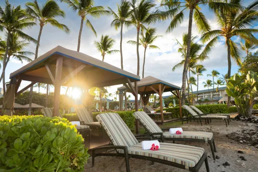 Rolled towels on reclining chairs by the beach