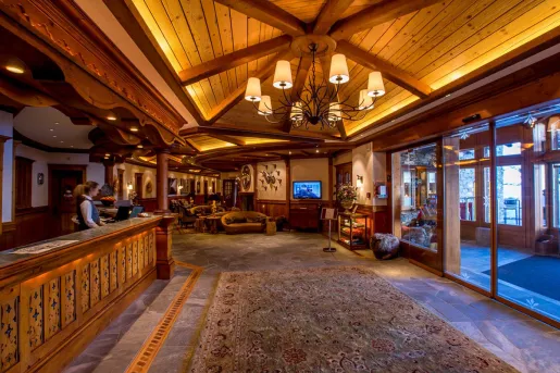 Hotel lobby with wooden furniture and a concierge at the desk