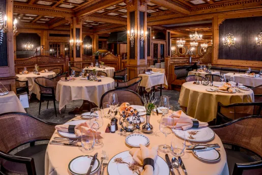 Indoor dining area with wine glasses and tables cloths