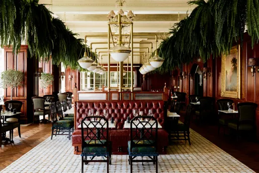 Indoor dining area with red cushioned booths and green chairs