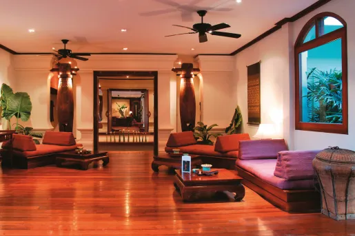 room with red lighting and low couches