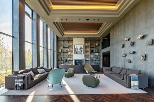 Indoor lounge with gray sofas and art fixtures along the walls