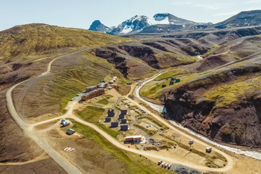 Hotel property in the middle of an empty valley of dirt and grass