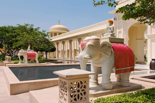 Outdoor courtyard with a rectangle pool and two statues of elephants