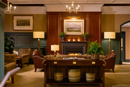 Hotel lobby with wooden fireplace and cushioned seats